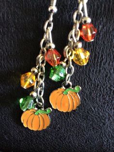 (13,034) Autumn Earrings  Made from stainless enamel, glass beads and stainless steel chain  A) Maple Leaf with Beads B) Pumpkin with orange, yellow and green beads C) Pumpkin with yellow, red and orange beads Orange Beaded Chain Jewelry For Gift, Orange Dangle Jewelry With Dangling Beads, Orange Czech Glass Dangle Earrings, Orange Jewelry With Dangling Beads, Orange Enamel Dangle Jewelry, Orange Czech Glass Beaded Jewelry, Nickel-free Yellow Dangle Beaded Earrings, Nickel Free Yellow Dangle Beaded Earrings, Orange Metal Earrings