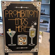 a sign that says prohibition ends here and two glasses with drinks on the table next to it