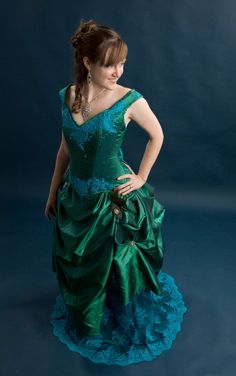 "This stunning handmade Victorian wedding gown was made for an Exhibit in the Springfield WVS art Museum where it was on display for 8 months in 2014. The corset features an emerald jewel toned taffeta hand appliqued with turquoise Indian lace, accented with swarovski crystals and swarovski rhinestones. It is boned with a combination of flat and spiral steel and has a strength layer of German coutil. The over skirt is made of the same taffeta accented with vintage rhinestone and stamped silver j Green Ball Gown Wedding Dress With Fitted Bodice, Green Fitted Bodice Corset Dress For Wedding, Green Corset Dress With Fitted Bodice For Wedding, Green Fitted Wedding Dress For Debutante Ball, Green Evening Dress With Boned Bodice For Wedding, Green Wedding Evening Dress With Boned Bodice, Green Wedding Corset Dress, Elegant Green Corset Dress For Wedding, Green Gown With Boned Fitted Bodice