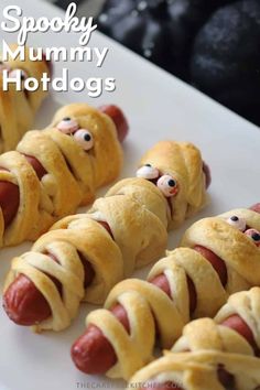 hotdogs wrapped in bread with googly eyes and mouthy mouths on them