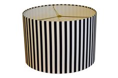 a black and white lampshade with a clock on the top, in front of a white background