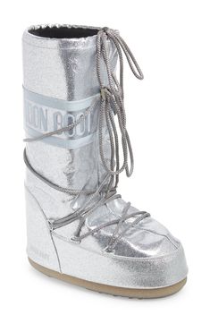 Break up the winter doldrums in cozy-glam style courtesy of this water-resistant, insulated Moon Boot doused with a shimmering flood of silvery glitter. The signature ambidextrous design and crisscrossing tubular laces keep you comfortable and secure no matter where your adventures lead. 14" shaft, 18 1/2" circumference (size 42) Lace-up style Drawcord-toggle cuff Water-resistant Textile and synthetic upper/synthetic lining/rubber sole Imported Silver Moon Boots Outfit, Silver Moon Boots, Ski Fits, 2025 Manifestation, Cozy Glam, Jean Skirts, Metallic Boots, 2024 Outfits, Glitter Boots