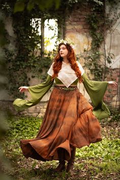 a woman with long red hair wearing a dress