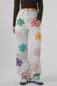 These High Waisted Jeans with Flowers bring a unique style to any wardrobe. With a loose fit featuring wide legs. pockets. and belt loops. you'll stay comfortable all day. The flowers and high waisted cut offer a fun. feminine look no matter the occasion.Fabric: Cotton. Polyester Paint On White Jeans, White Jeans Painting, Painted White Jeans, Jeans With Flowers, Paint Pants, Kid Core Outfits, White High Waisted Jeans, Funky Pants, Flower Jeans