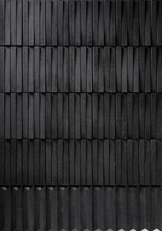 a black and white photo of some sort of textured wallpaper that looks like wood planks