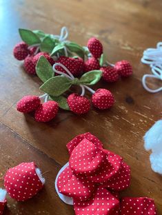 some red and white polka dot hearts on a wooden table