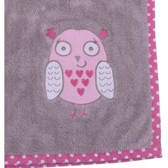 a pink and gray owl with hearts on it's face sitting on a polka dot blanket