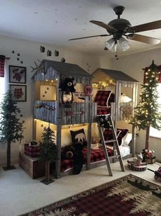 there is a bunk bed with christmas decorations on the top and below it, next to a tree