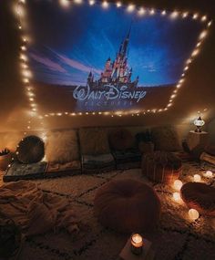 a bedroom with lights on the ceiling and a disney poster above it