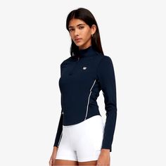 When the temperature dips on court, slip the Brentwood Half Zip over one of our Bramis and keep going. Sleek and stretchy, it keeps you moving freely. The smooth bonded details are inspired by the tape on a tennis ball. Slide the thumbhole sleeves over cold hands for extra coverage, and stash cards or cash inside the zip pocket. Athletic Fit Storage pocket Thumbholes for secure fit Yacht Uniform, Tennis Fits, Wilson Sporting Goods, Tennis Outfit Women, Iron Woman, Tennis Outfits, Tennis Fashion, Compression Fabric, Cold Hands