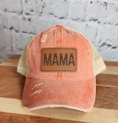 Being a mom doesn't mean you have to sacrifice your sense of style. Embrace the chic and trendy side of motherhood with our Trendy Mama Hat! This hat is designed exclusively for mamas who want to stay fashionable while juggling their busy lives. Crafted with both fashion and functionality in mind, our Women's Ponytail Hat features a cleverly designed opening at the back, allowing you to comfortably wear your ponytail or bun without compromising on style. Say goodbye to awkwardly squeezing your h Brown Trucker Hat With Letter Patch And Curved Brim, Mama Hats, Brown Trucker Hat With Patches, Boy Mom Hat, Baseball Mom Hats Ball Caps, Ponytail Hat, Girl Mom, Boy Mom, Cute Hats