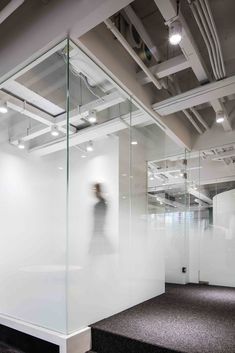 an office with glass walls and black carpet