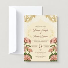 an elegant wedding card with pink flowers and gold trimmings on the front, in cream