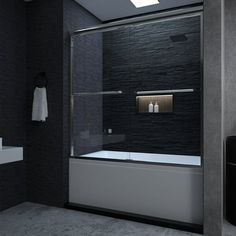 a black and white bathroom with a glass shower door