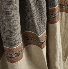 closeup of the back of a curtain with brown and white designs on it's fabric