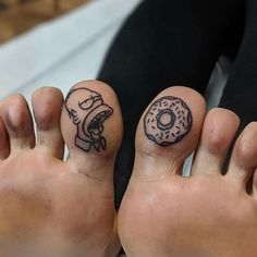 two people with tattoos on their feet and one has a donut tattooed on it