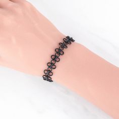 "Adorn your wrist with this elegant multi circle link bracelet. Its simple design makes it the perfect accessory for any outfit! 💀 DESCRIPTION: This metal bracelet was created with a matte black chain that features multiple loops held together with rectangular links. The bracelet was finished with a lobster clasp and an extender. 💀 SIZE: The chain was made from brass that was electroplated with a midnight black finish. The bracelet measures 7\" long by 1/2\" wide. 💀 GIFT: This tattoo style br Trendy Black Metal Chain Bracelet, Round Black Metal Chain Bracelet, Black Metal Bangle Charm Bracelet, Trendy Black Alloy Bracelets, Black Metal Charm Bracelet With Chain Detail, Punk Style Chain Bracelets, Black Metal Hypoallergenic Bracelets, Black Hypoallergenic Metal Bracelets, Hypoallergenic Black Metal Bracelets