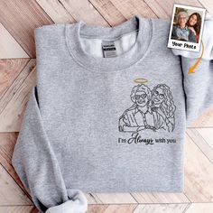 Introducing our Personalized Photo Embroidered Sweatshirt a unique and heartwarming way to showcase your cherished memories. Crafted with care, this sweatshirt features an intricately embroidered photo, creating a wearable masterpiece that captures the essence of your special moments. Whether it's a picture of a loved one, a cherished pet, or a memorable event, our Personalized Photo Embroidered Sweatshirt turns your favorite photos into a one-of-a-kind garment. It serves as a comforting Memoria Expressing Sympathy, Embroidered Photo, Mom Daughter Gifts, Forever In My Heart, Family Friend, Embroidered Sweatshirt, Leather Keychain, Embroidered Sweatshirts, Cherished Memories