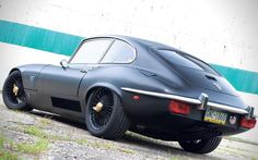 a black sports car parked in front of a building