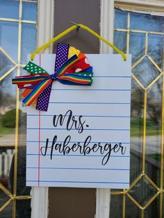 a sign that says mrs harberger on the side of a door with a bow