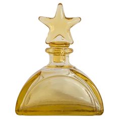 an empty glass bottle with a gold star on it's top and bottom half