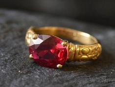 Gold Ruby Ring set with a created Ruby in a flawless diamond cut & clarity, deep red color (10x8mm, 3Ct). Made of Gold Vermeil ☞ thickest 18k Gold Plating on Solid 925 Sterling Silver ☞ made to last. Matching Pendant: www.etsy.com/listing/963627546 Matching Earrings - please ask me ☞ Choose your size ☞ I resize (before shipping) for FREE to Any size* *Sizes 13-16 U.S. need to be custom made & May include an additional cost, I will contact you before starting work on those custom-made sizes with Red Solitaire Ring For Promise, Red Solitaire Promise Ring, Red Jewelry With Center Stone In Round Band, Red Jewelry With Center Stone Round Band, Red Ruby Ring For Promise With Round Band, Red Ruby Promise Ring With Round Band, Red Round Band Promise Jewelry, Red Garnet Round Band Jewelry, Red Jewelry With Accent Stones And Round Band