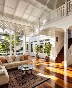 a living room filled with furniture and lots of wood flooring on top of a hard wood floor