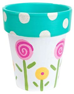 a flower pot with polka dots and flowers painted on the outside, sitting in front of a white background