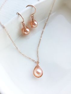 ✨ Dainty Pink Pearl Necklace and Earrings Set with 14K Gold Fill or Sterling Silver ✨ • Simple & elegant with genuine freshwater pearls. Simple and beautiful bridal jewelry set. A perfect gift & affordable treat for yourself. • Pearl Size: 7 mm • Earrings Drop Length: 2 cm • 14K gold-filled & sterling silver wire is known for its lasting quality. This jewelry will last for decades with proper care and is considered a lifetime piece of jewelry. • The jewelry won’t tarnish. You can wear them every Pearl Earrings And Necklace, Pearl Necklace And Earrings, Silver Pearl Jewelry, Pink Pearl Earrings, Pearl Jewelry Set, Beautiful Bridal Jewelry, Earrings And Necklace Set, Pink Pearl Necklace, Gold Pearl Ring