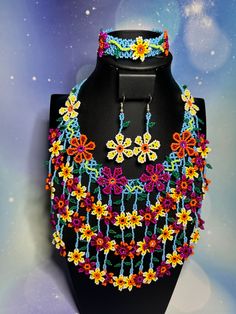 This stunning Chaquira Set necklace is a true masterpiece of Huichol Jewelry, showcasing the vibrant and intricate design of Mexican Jewelry. Each piece is meticulously handcrafted with colorful beads, making it a unique and eye-catching addition to your collection of Beaded Jewelry. This Artisan Jewelry is a perfect choice for those who appreciate quality craftsmanship and artistic flair. Handmade with care, this set would make a memorable Birthday Gift for a loved one or a special treat for yourself. Elevate your look with this exquisite Woman Jewelry that is sure to turn heads and spark conversation. Make a statement with this one-of-a-kind piece that is a true work of art. Here are the measurements for the set:  The necklace neck circumference is 18 inches with an additional 5.5-inch h Huichol Jewelry, Beads Making, Jewelry Colorful, Woman Jewelry, Mexican Jewelry, Set Necklace, Intricate Design, Artisan Jewelry, Jewelry Sets