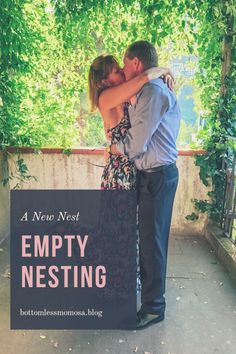 a man and woman kissing in front of an empty nest sign with the words empty nesting on it