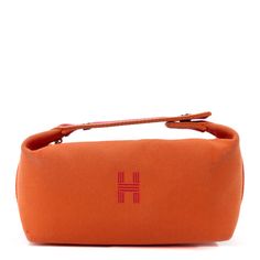 This is an authentic HERMES Canvas Small Bride-A-Brac Pouch in Orange Burgundy. The pouch is fabricated in orange canvas. The bag consists of a snap closure on the top handle, along with a burgundy stripe around the bag, and a frontal H logo. The top zipper opens to a beige canvas interior with patch pockets. Orange Canvas Travel Bag, H Logo, H Logos, Toiletry Bags, The Pouch, Snap Closure, Patch Pocket, Top Handle, Pouch