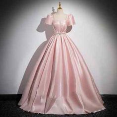 a pink dress on display in a room