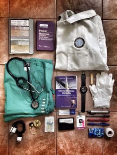 the contents of a doctor's bag laid out on top of a tile floor