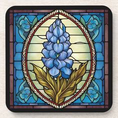 a stained glass window with blue flowers and leaves in the center beverage coasters, set of 4