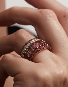 A luminous ring, with rubies. A unique stacking ring, a subtle wedding band, or a wedding band and engagement ring all in one. 14K sustainable gold Center: 0.07ct ruby baguette 0.29 tcw round rubies Dimensions: Band width 1.9mmDelivery: Please allow up to 1-2 weeks for delivery. For rush orders please contact our Concierge. Baguette Ruby Ring, Rose Gold Stackable Rings With Baguette Cut, Ruby Ring Stack, Vintage Ring Stack, Rose Gold Ring Stack, Luminous Ring, Ruby Jewelry Ring, Ruby Ring Designs, Vintage Ruby Ring