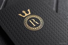 a black and gold business card with the letter r on it's front cover