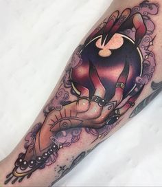 a woman's leg with an artistic tattoo on it