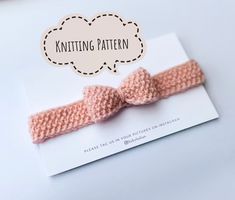 a pink knitted bow with a thought bubble above it that says knitting pattern on the side