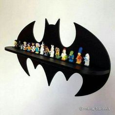 a shelf with lego batman figurines sitting on it's sides and the bottom section