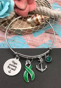 This listing is for the green ribbon Hope Anchors the Soul charm bracelet. Please contact me if you need a different ribbon color. * The 1-inch pendant is laser cut, silver, and reads: Hope Anchors the Soul * Cause ribbon charm is sterling silver plate and acrylic. It measures an inch tall. * Also included are a Sterling silver plated pave' anchor and a Swarovski crystal charm to compliment your ribbon. * The silver plated bangle bracelet is adjustable in size by squeezing or stretching the slid Duchenne Muscular Dystrophy Awareness, Hope Anchors The Soul, Nephrotic Syndrome, Lime Green Ribbon, Hope Anchor, Awareness Jewelry, Survivor Gift, Ribbon Bracelets, Ribbon Jewelry