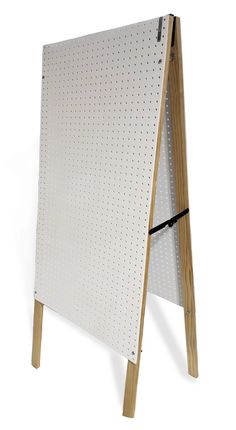 a white board with wooden legs and pegs attached to it, on a white background