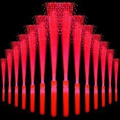 a large number of red candles are arranged in the shape of a pyramid on a black background