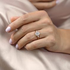 a woman's hand with a diamond ring on it