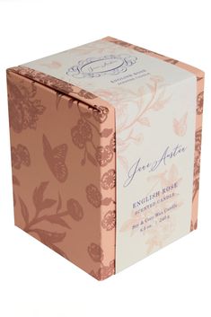 a pink and white box with an orange flower design on the front, sitting on a white surface