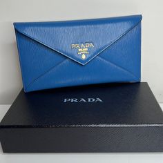 Just Purchased In Italy This Is A Gorgeous Prada Slim Envelope Wallet In Cobalt Blue Leather! Can Also Be Used As A Clutch. Stunning!!!!!! Gold Hardware. Fits Credit Cards And Perfect To Hold Cash Or Receipts. Has A Zip Pocket On The Back For Coins. Comes With Box And Authenticity Certificate. Makes A Gorgeous Gift! All Brand Brand New!! Super Pretty! Blue Is Even More Beautiful In Person. Formal Blue Bags With Card Slots, Classic Blue Clutch For Travel, Classic Blue Travel Clutch, Designer Blue Bags With Card Slots, Blue Designer Bags With Card Slots, Luxury Blue Clutch For Travel, Luxury Blue Wallet For Formal Occasions, Designer Blue Wallet For Formal Occasions, Designer Blue Wallets For Formal Occasion