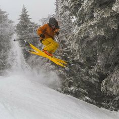 a man flying through the air while riding skis