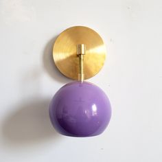 a purple ball hanging from the side of a wall