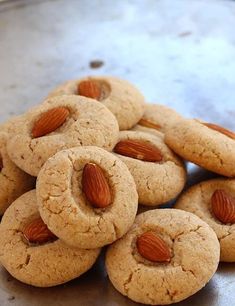 almonds are arranged on top of some cookies