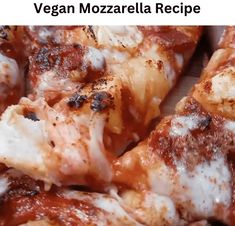 a pizza with cheese and sauce on it is sitting in a cardboard box that says vegan mozzarella recipe